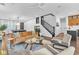 Spacious living room with ample seating, staircase, and contemporary décor at 10432 Britton Hill Ave, Las Vegas, NV 89129
