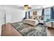 Main bedroom features a plush bed, stylish rug, and inviting seating area with natural light at 10432 Britton Hill Ave, Las Vegas, NV 89129