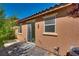 Private patio area featuring neutral stucco, a sliding glass door, and small windows, providing a peaceful outdoor living space at 1139 Via Partito, Henderson, NV 89052