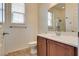 Bathroom featuring wood cabinets, a mirror, a sink, and a toilet at 1139 Via Partito, Henderson, NV 89052