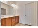 Bathroom features a double vanity with wood cabinets and a large mirror at 1139 Via Partito, Henderson, NV 89052