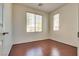 Bright bedroom with hardwood flooring, natural light, and two windows at 1139 Via Partito, Henderson, NV 89052