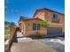 Charming two-story home with a two-car garage, landscaped yard, and a brick walkway to a private fenced entryway at 1139 Via Partito, Henderson, NV 89052