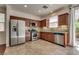 Updated kitchen featuring stainless steel appliances, granite counters, tile backsplash, and wood cabinets at 1139 Via Partito, Henderson, NV 89052