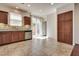 Bright kitchen features wood cabinets, stainless steel appliances, tile floor, and sliding glass door at 1139 Via Partito, Henderson, NV 89052