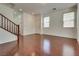 Open-concept living room with hardwood floors, natural light, and staircase access at 1139 Via Partito, Henderson, NV 89052