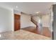 Open concept living space showcasing hardwood floors and seamless flow between kitchen and staircase at 1139 Via Partito, Henderson, NV 89052