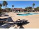 Community pool offers ample lounge chairs and shade for relaxation at 1139 Via Partito, Henderson, NV 89052