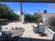 View of spacious backyard featuring an outdoor patio and mature landscaping at 1281 Challenge Ln, Las Vegas, NV 89110
