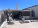 Backyard exterior with patio, showing mature landscaping around back facade of the house at 1281 Challenge Ln, Las Vegas, NV 89110