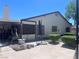 Exterior view of backyard with patio, showing home's back facade and mature plantings at 1281 Challenge Ln, Las Vegas, NV 89110
