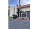 A two-story condo with a red tiled roof and stucco exterior, set amidst green landscaping at 1440 Vegas Valley Dr # 2, Las Vegas, NV 89169