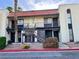 Two-story condo featuring a red tile roof and a well-maintained stucco exterior with black metal railings at 1440 Vegas Valley Dr # 2, Las Vegas, NV 89169