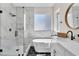 Bathroom featuring a soaking tub, a walk-in shower, and marble countertops at 1551 Boundary Peak Way, Las Vegas, NV 89135