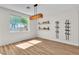 Bright dining room featuring hardwood floors, a modern light fixture, and decorative shelving at 1551 Boundary Peak Way, Las Vegas, NV 89135