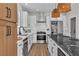 Modern kitchen features stainless steel appliances, white cabinets, and a marble backsplash at 1551 Boundary Peak Way, Las Vegas, NV 89135