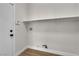 Laundry room with utility sink hook ups, a white door and single shelf for storage at 1551 Boundary Peak Way, Las Vegas, NV 89135
