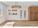 Bright living room featuring floating shelves, wine rack, and built in cabinets at 1551 Boundary Peak Way, Las Vegas, NV 89135