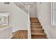 Bright staircase features wood steps, white railing and baseboards, and natural light from the windows at 1551 Boundary Peak Way, Las Vegas, NV 89135