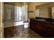 Well-lit bathroom featuring a shower-tub combo and dark wood vanity at 1608 Sussex St # 204, Las Vegas, NV 89144