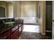 Bathroom featuring a soaking tub, tiled floors, and granite vanity at 1608 Sussex St # 204, Las Vegas, NV 89144