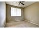 Cozy bedroom with neutral carpet, ceiling fan, and bright window at 1608 Sussex St # 204, Las Vegas, NV 89144