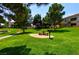 Grassy common area featuring mature trees and picnic tables at 1608 Sussex St # 204, Las Vegas, NV 89144