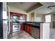 Efficient kitchen featuring stainless steel appliances, dark wood cabinetry, and an open layout at 1608 Sussex St # 204, Las Vegas, NV 89144