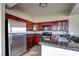 Modern kitchen equipped with stainless steel appliances, wood cabinets, and sleek countertops at 1608 Sussex St # 204, Las Vegas, NV 89144