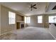 Comfortable living room boasting a fireplace, large windows, and modern ceiling fan for a relaxing ambiance at 1608 Sussex St # 204, Las Vegas, NV 89144