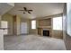 Cozy living room featuring a classic fireplace, neutral carpet, and bright natural light at 1608 Sussex St # 204, Las Vegas, NV 89144