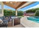 Stylish backyard with a pool, a covered patio, and comfortable outdoor furniture at 1777 Antelope Valley Ave, Henderson, NV 89012