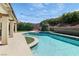 Lush backyard with a private pool, complemented by green landscaping, and outdoor seating at 1777 Antelope Valley Ave, Henderson, NV 89012