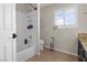 Bright bathroom featuring a white shower-tub combo and decorative bathroom accents at 1777 Antelope Valley Ave, Henderson, NV 89012