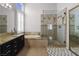 Well-lit bathroom with a double sink vanity, soaking tub, and frameless glass shower at 1777 Antelope Valley Ave, Henderson, NV 89012
