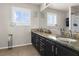 Bright bathroom featuring a double sink vanity and a large mirror at 1777 Antelope Valley Ave, Henderson, NV 89012
