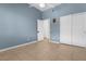 Bright bedroom with blue walls, tile floors, and a closet with sliding doors at 1777 Antelope Valley Ave, Henderson, NV 89012