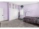 Cozy bedroom with lavender walls, a unique decorative tree, and a comfortable bed at 1777 Antelope Valley Ave, Henderson, NV 89012