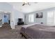 Large bedroom with a ceiling fan, carpet flooring, and plantation shutters at 1777 Antelope Valley Ave, Henderson, NV 89012