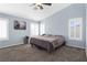 Large bedroom with carpet, ceiling fan, light blue walls, and plantation shutters at 1777 Antelope Valley Ave, Henderson, NV 89012