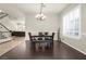 Elegant dining room with dark wood floors, wainscoting, and a modern chandelier at 1777 Antelope Valley Ave, Henderson, NV 89012