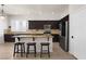 Modern kitchen with dark wood cabinets, stainless steel appliances, and a center island at 1777 Antelope Valley Ave, Henderson, NV 89012