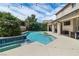 Relaxing backyard pool with a connected spa and lush landscaping creates a private oasis at 1777 Antelope Valley Ave, Henderson, NV 89012