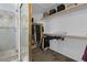 Walk-in closet with custom shelving for optimal storage, and a shower at 1777 Antelope Valley Ave, Henderson, NV 89012