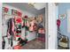 Organized walk-in closet with clothes, bins and a prize winning trophy at 1777 Antelope Valley Ave, Henderson, NV 89012
