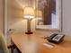 Desk with lamp, art and telephone at 211 E Flamingo Rd # 620, Las Vegas, NV 89169