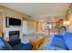 Bright living room with fireplace, TV, comfortable seating, and an adjacent kitchen space at 211 E Flamingo Rd # 620, Las Vegas, NV 89169