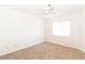 Bright bedroom with neutral carpet, ceiling fan, and natural light from a window at 2191 Bay Club Dr # 204, Laughlin, NV 89029