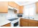 Functional kitchen showcasing stainless steel sink, electric range, and microwave at 2191 Bay Club Dr # 204, Laughlin, NV 89029