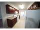 Kitchen featuring white appliances, dark wood cabinets and tile floor at 2606 S Durango Dr # 264, Las Vegas, NV 89117